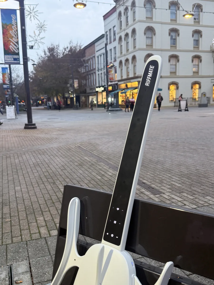 RIFFMATE smart guitar in downtown Ithaca at dusk, New York